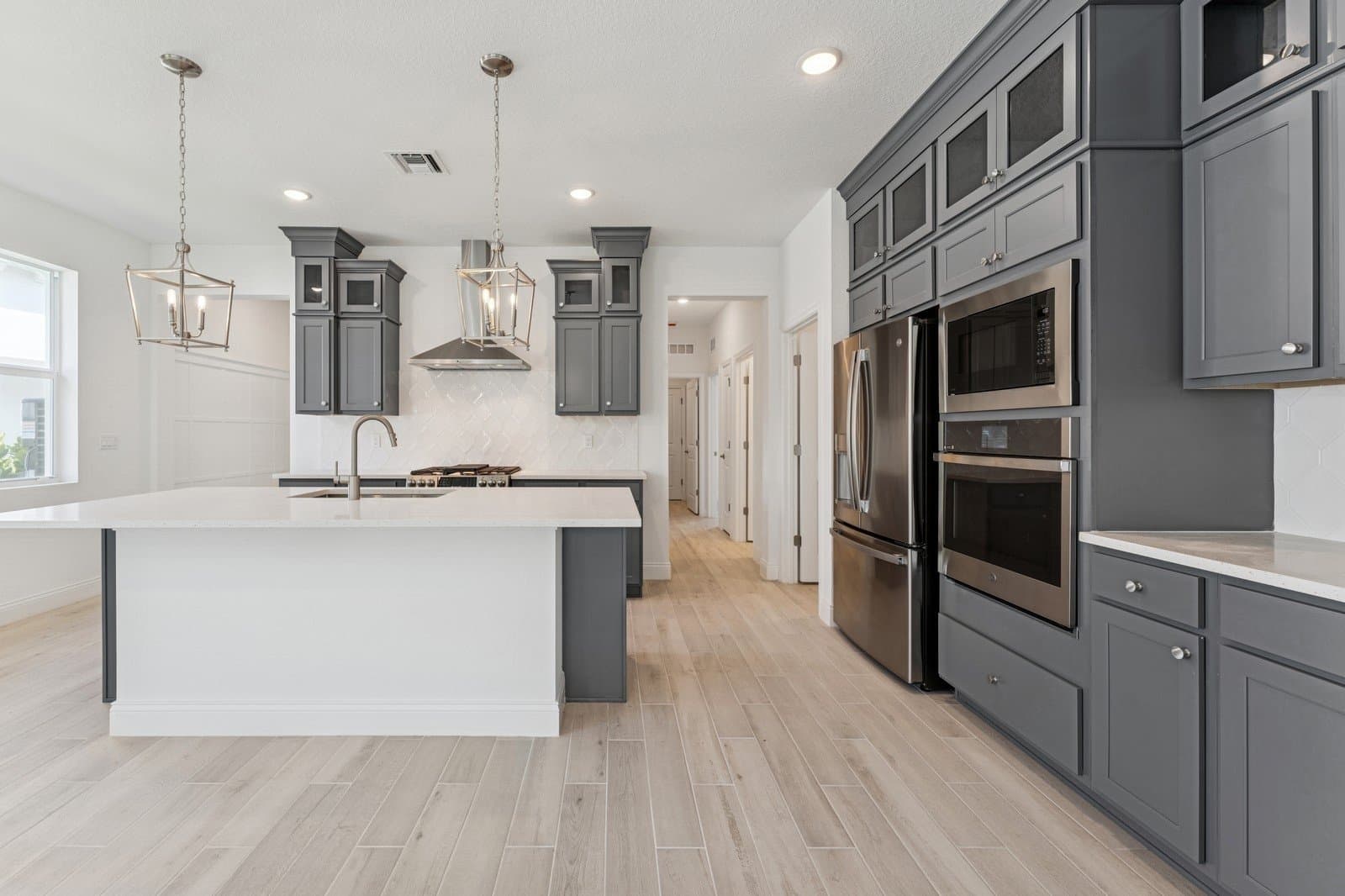 Kitchen with stacked glass-front upper cabinets
