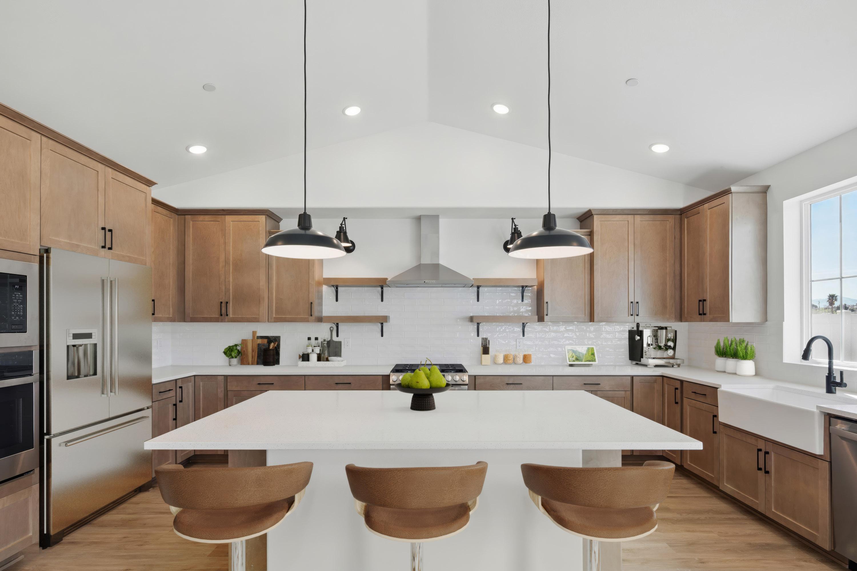 Kitchen with pendant lights and quartz island 