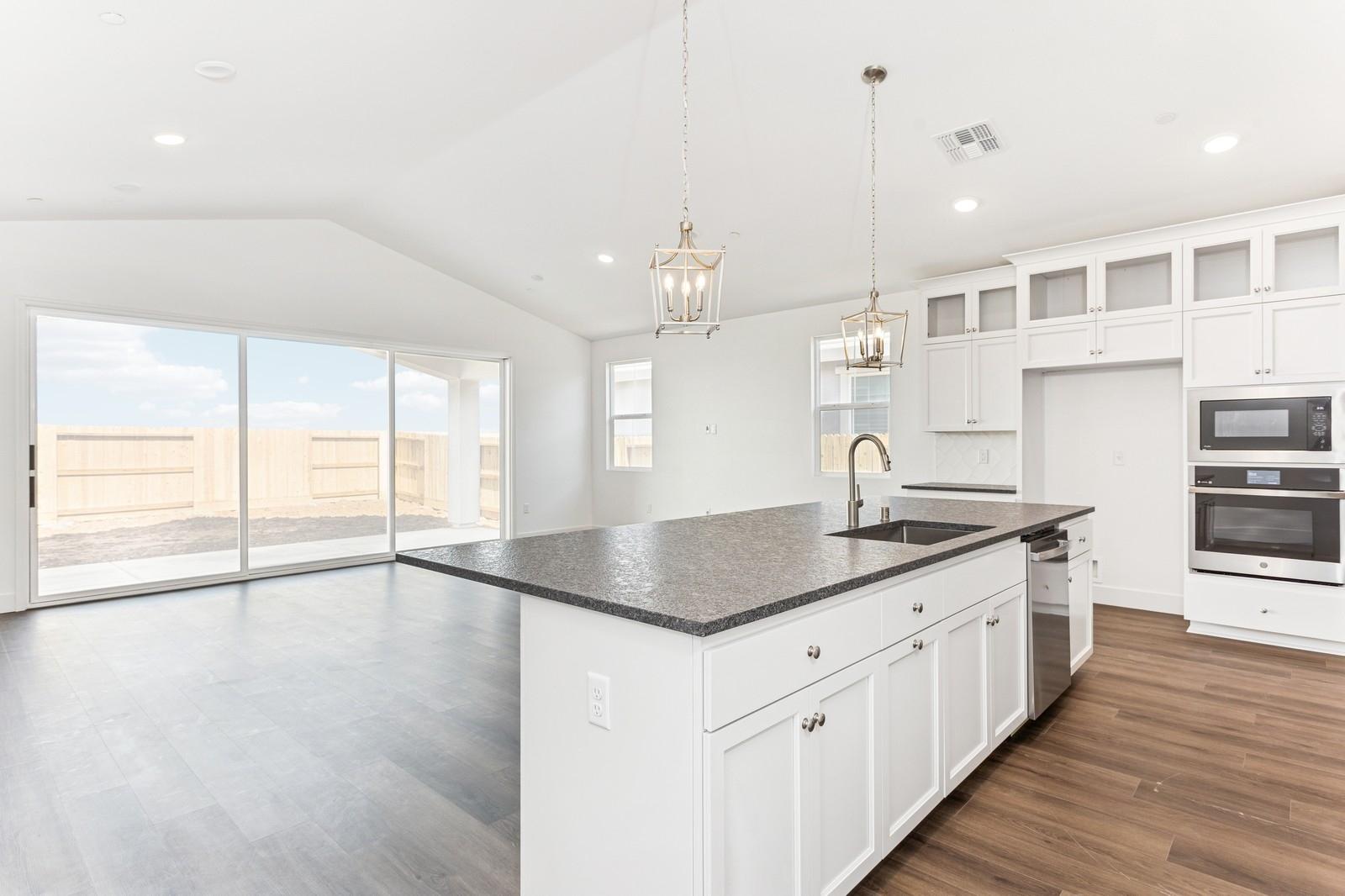 Soaring vaulted ceiling unites main living spaces