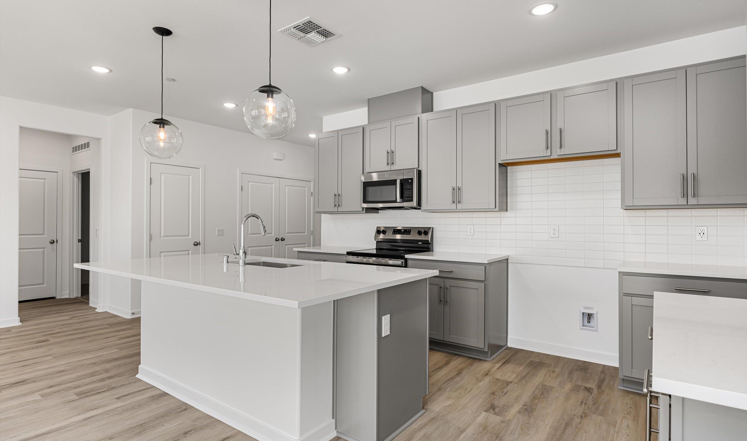 Kitchen with sleek pendant lighting