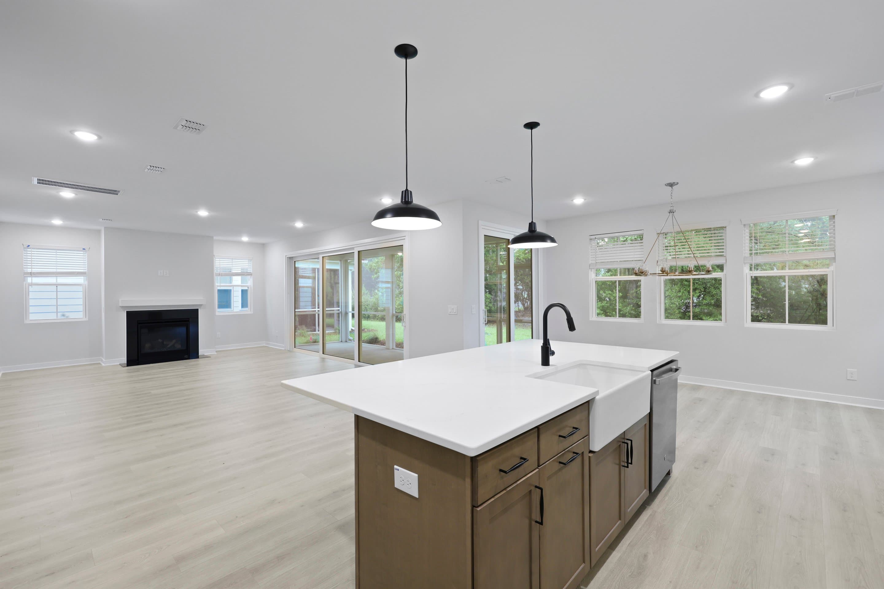 Kitchen featuring vast island & pendant lights
