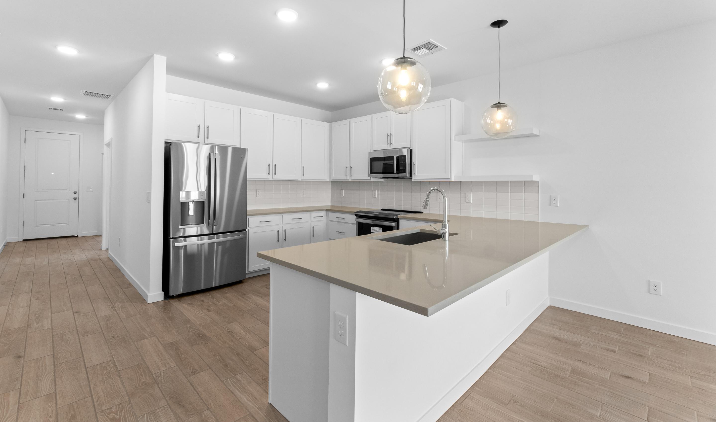 Kitchen with peninsula island & pendant lights