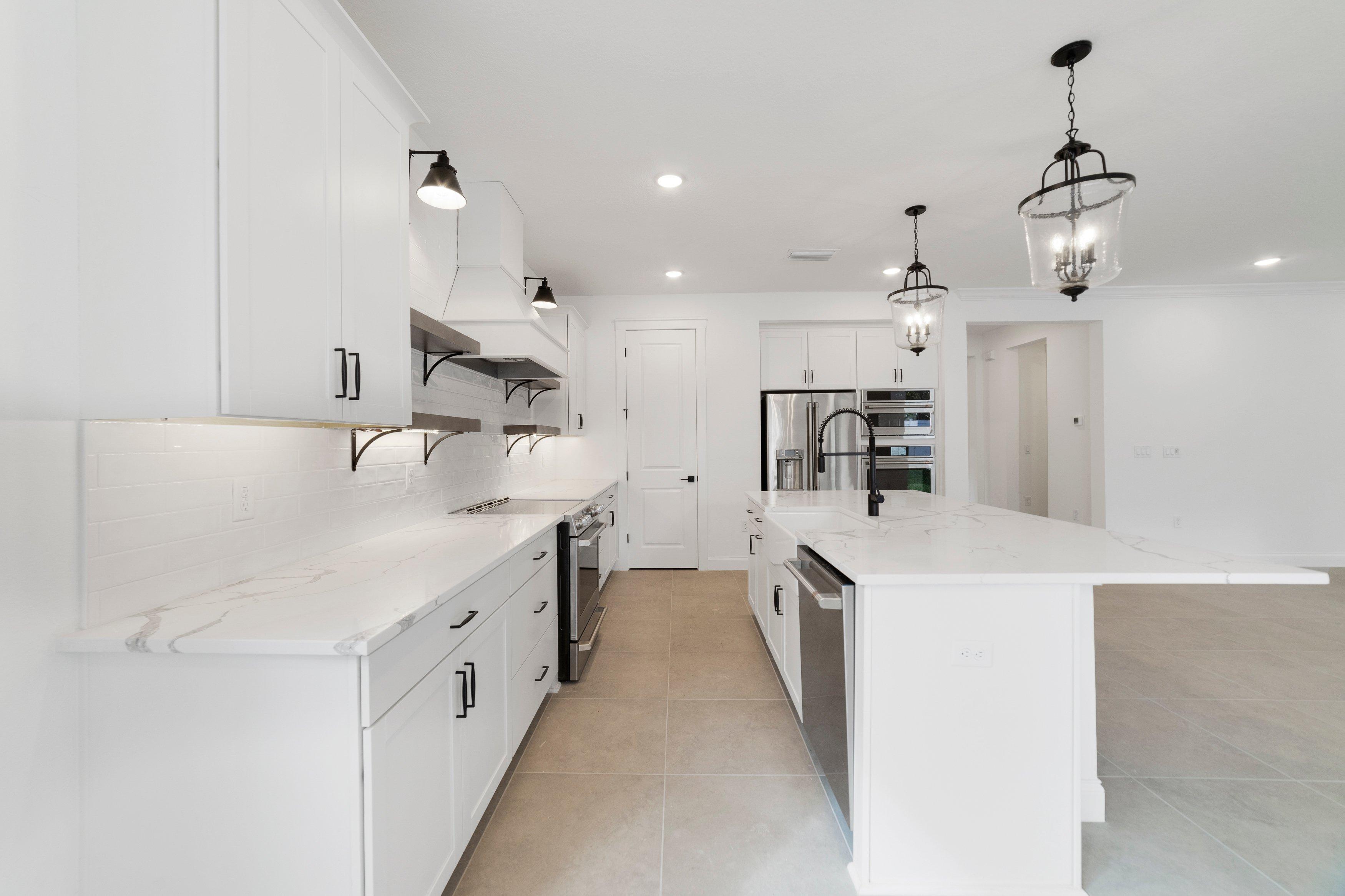 Kitchen with white cabinets and quartz countertops