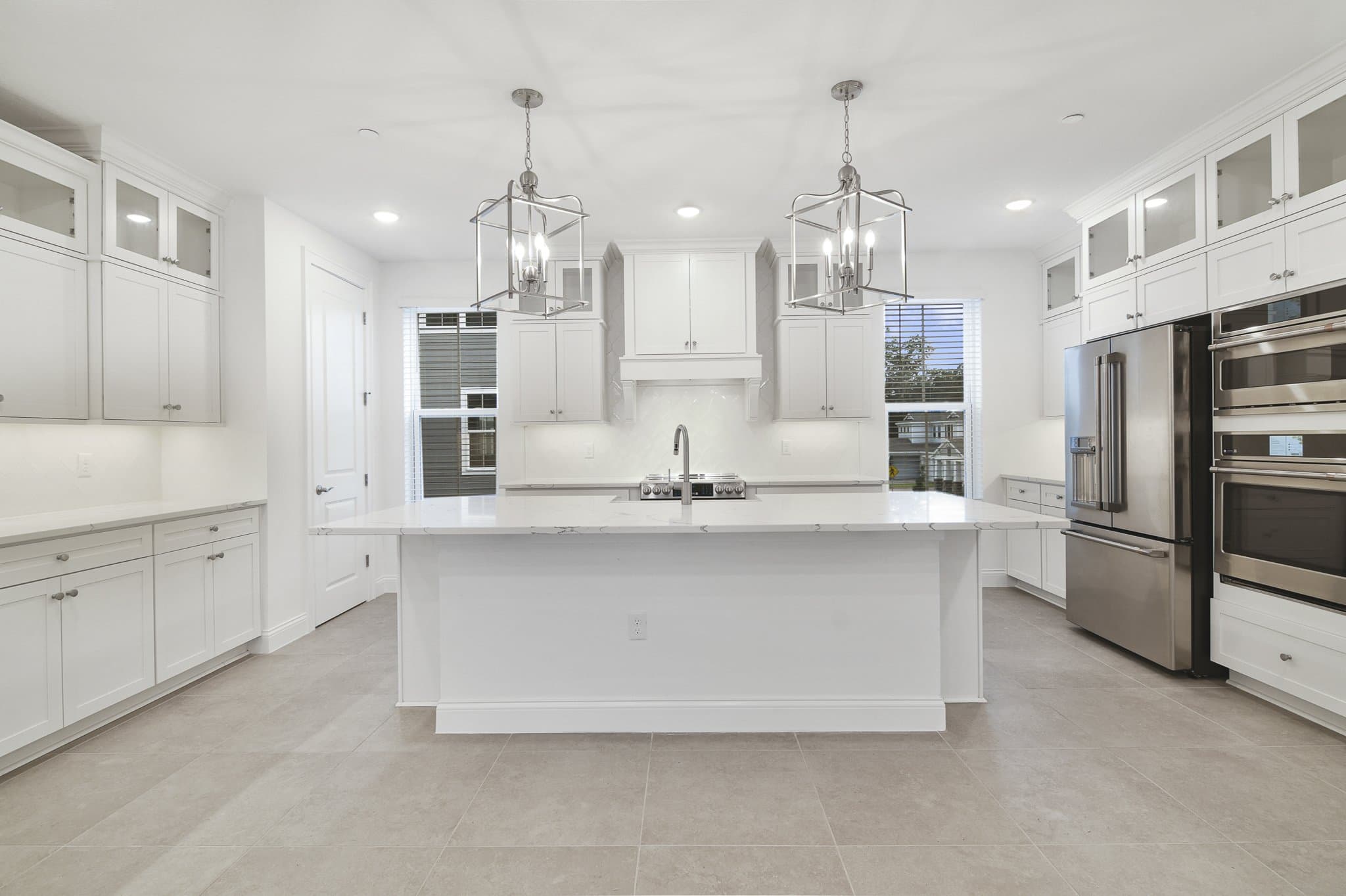 Kitchen with brushed nickel pendant lighting