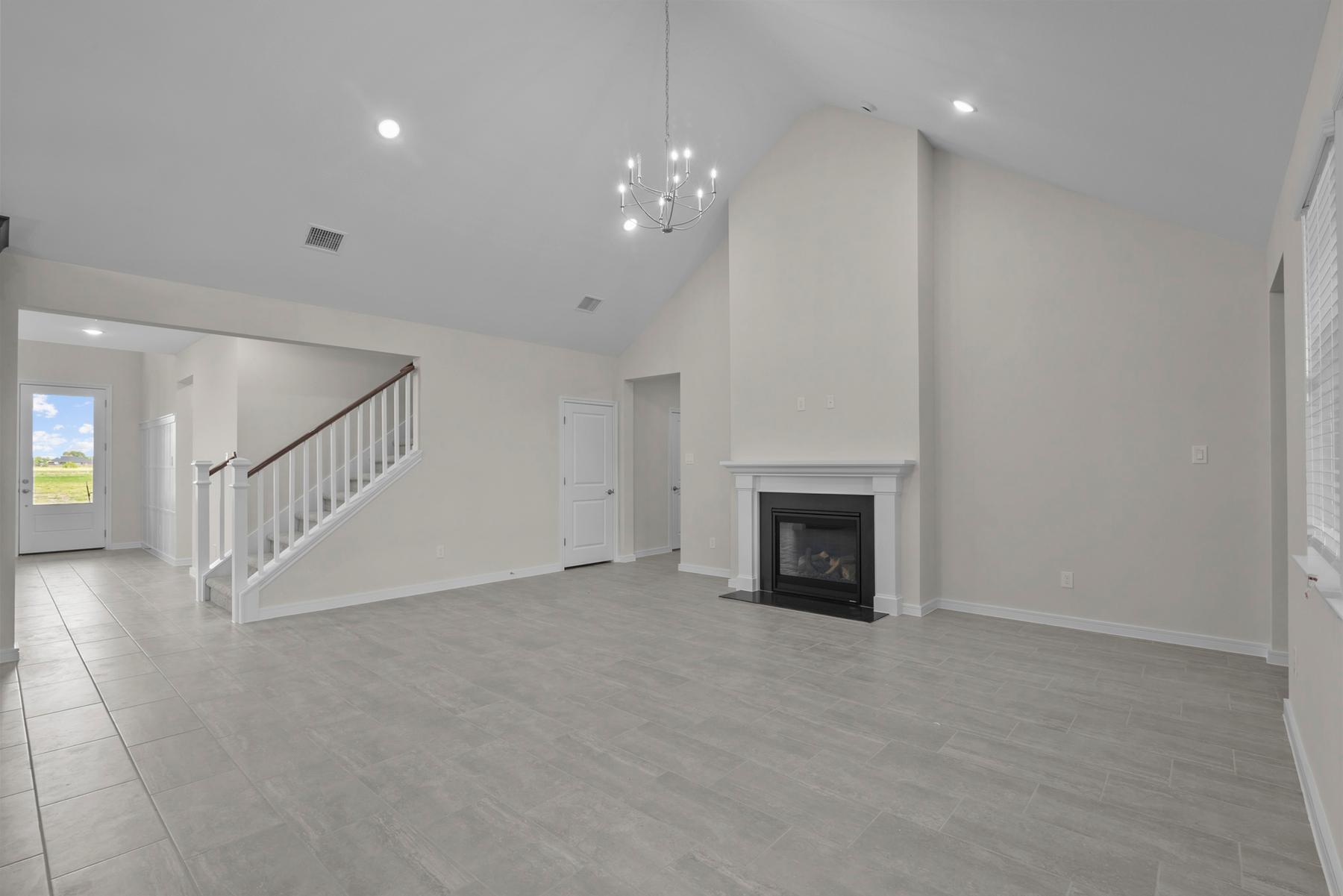 Great room with chandelier & fireplace