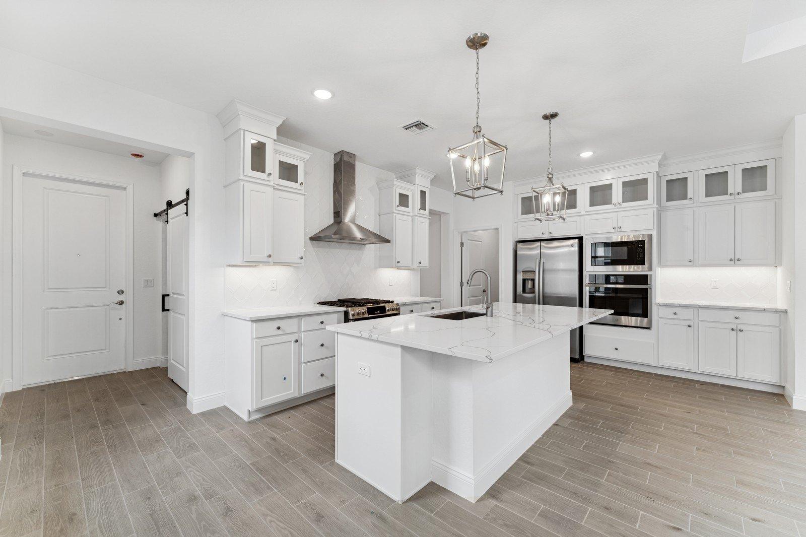 Kitchen with stacked glass-front upper cabinets