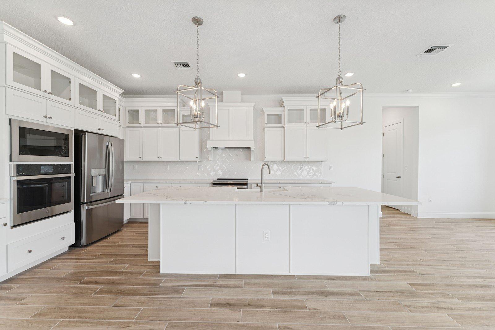 Kitchen with stacked glass-front upper cabinets
