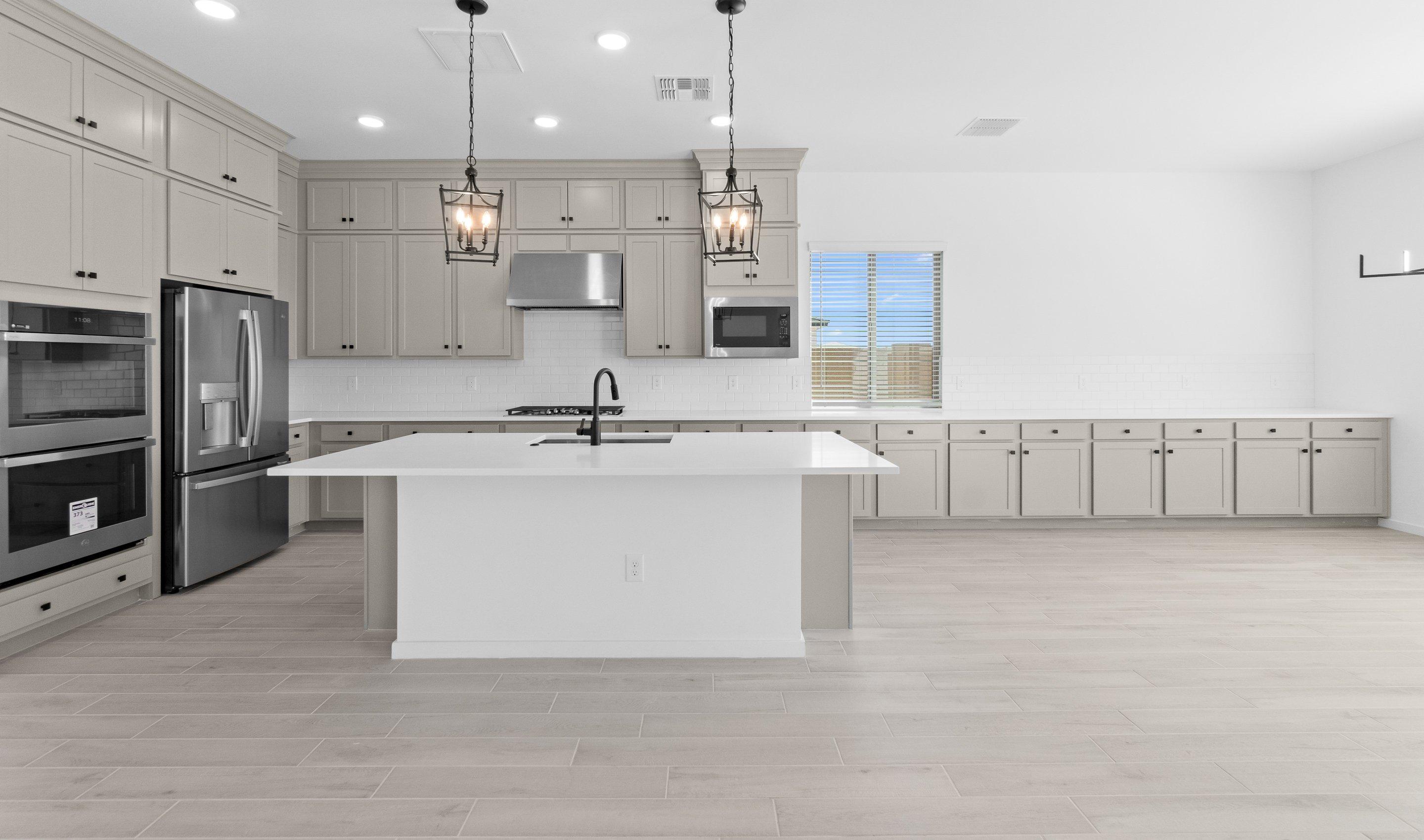 Kitchen with vast island & pendant lights