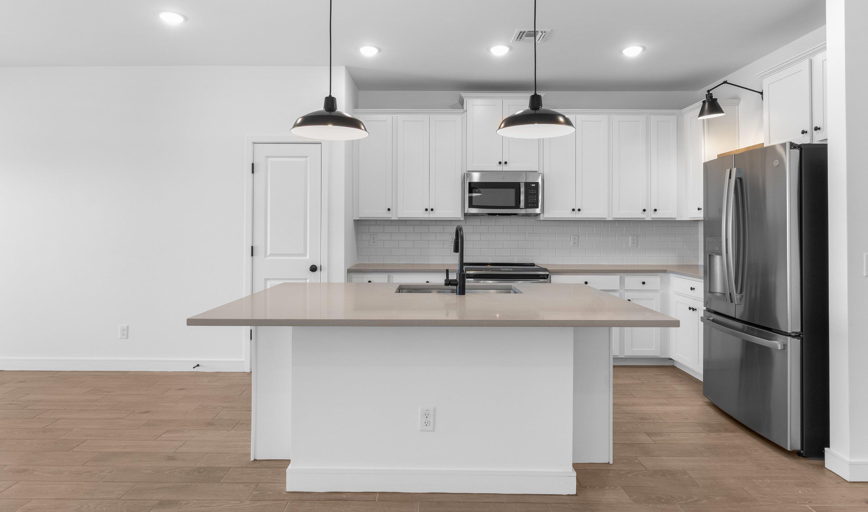 Kitchen with gray quartz countertops