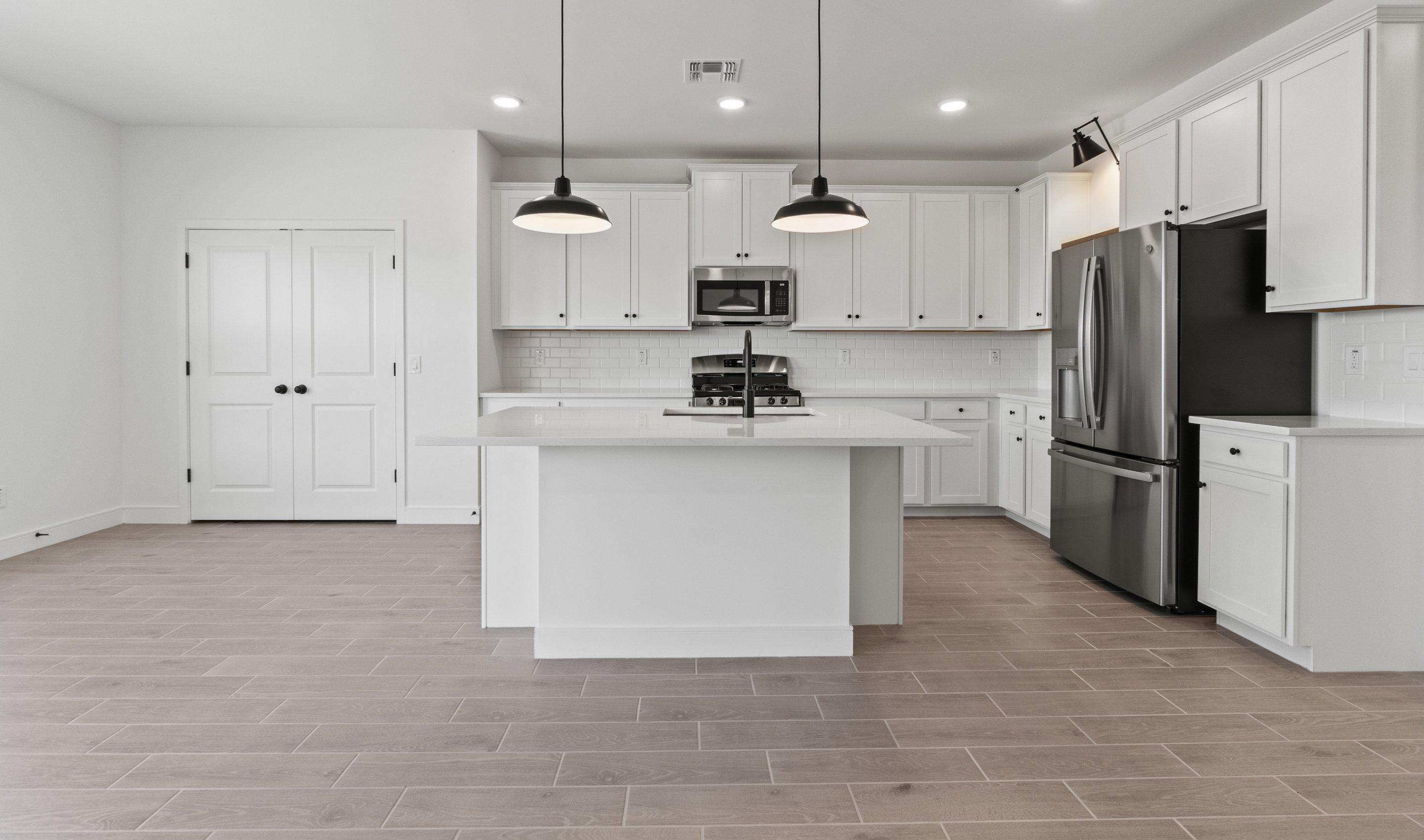 Kitchen with vast island & pendant lights
