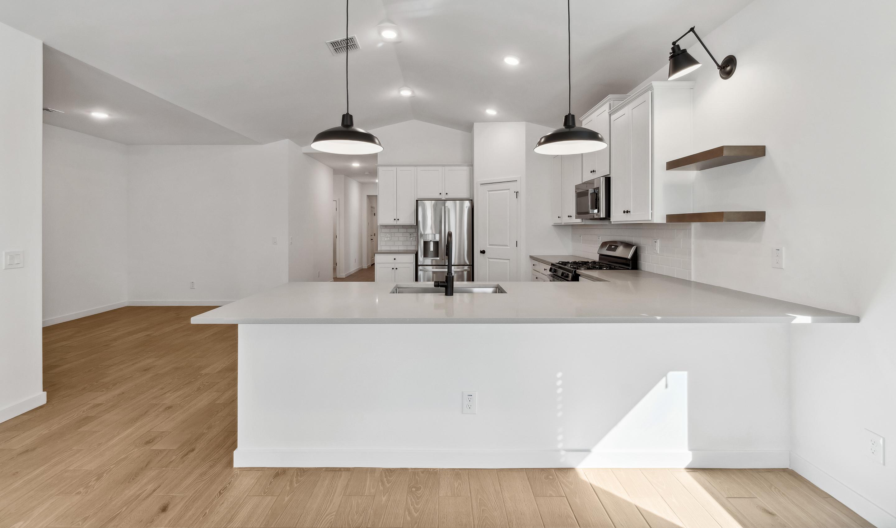 Kitchen with pendant lights & floating shelves