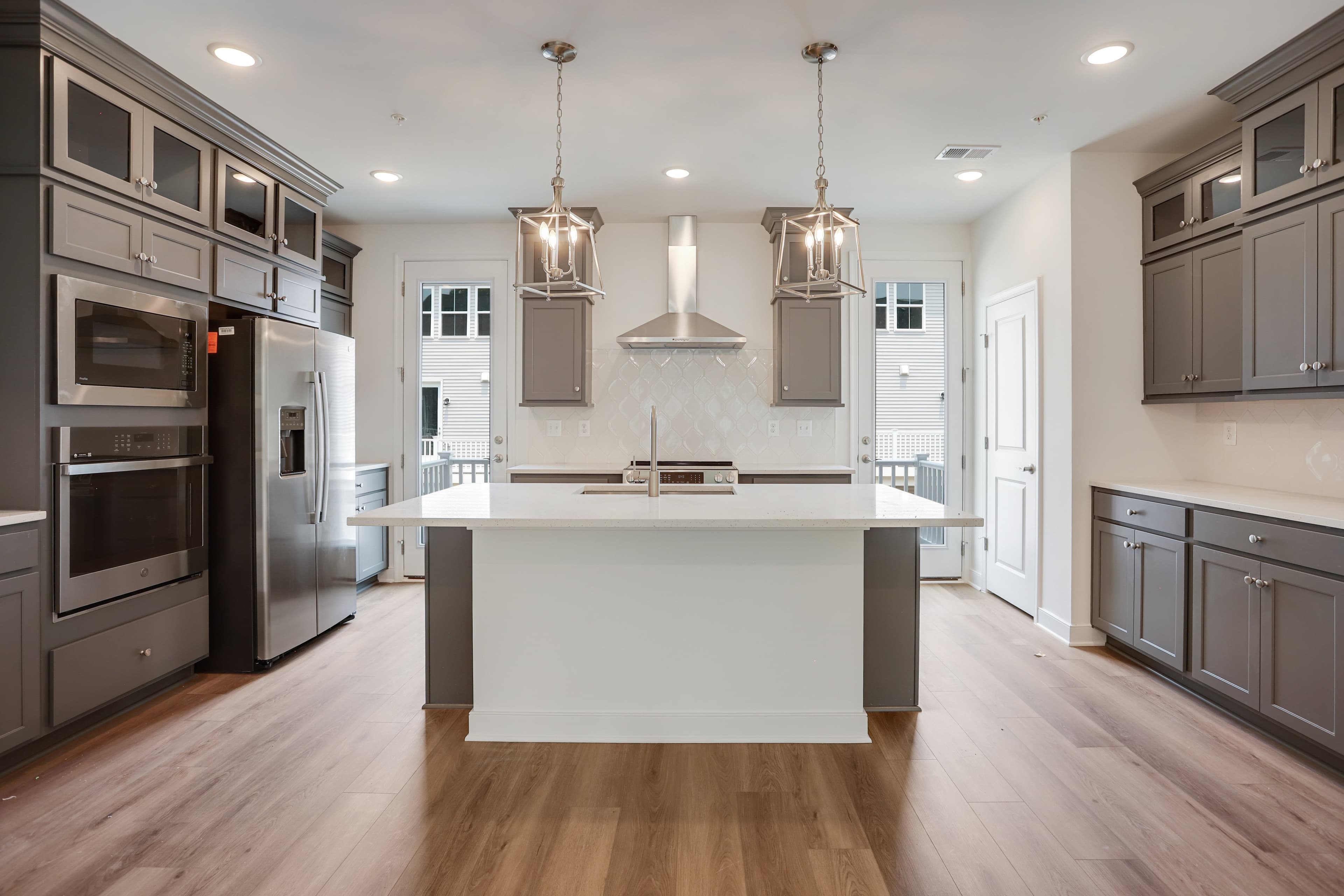 Kitchen with stacked glass-front upper cabinets