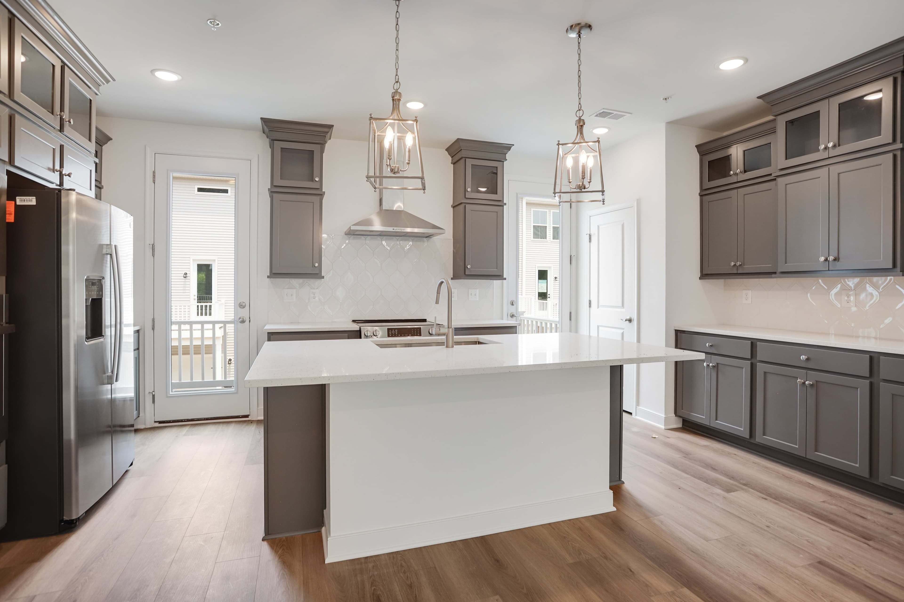 Kitchen with dual doors to deck for seamless indoor-outdoor living