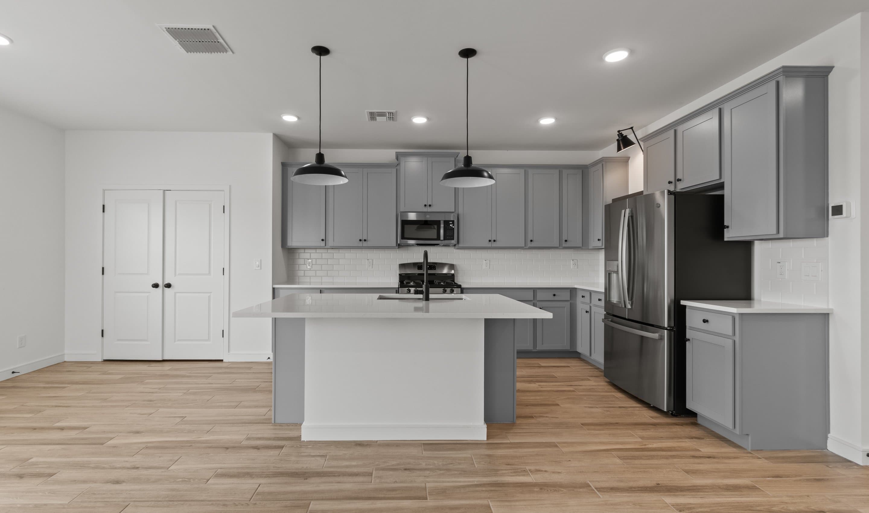 Kitchen with matte black pendant lighting