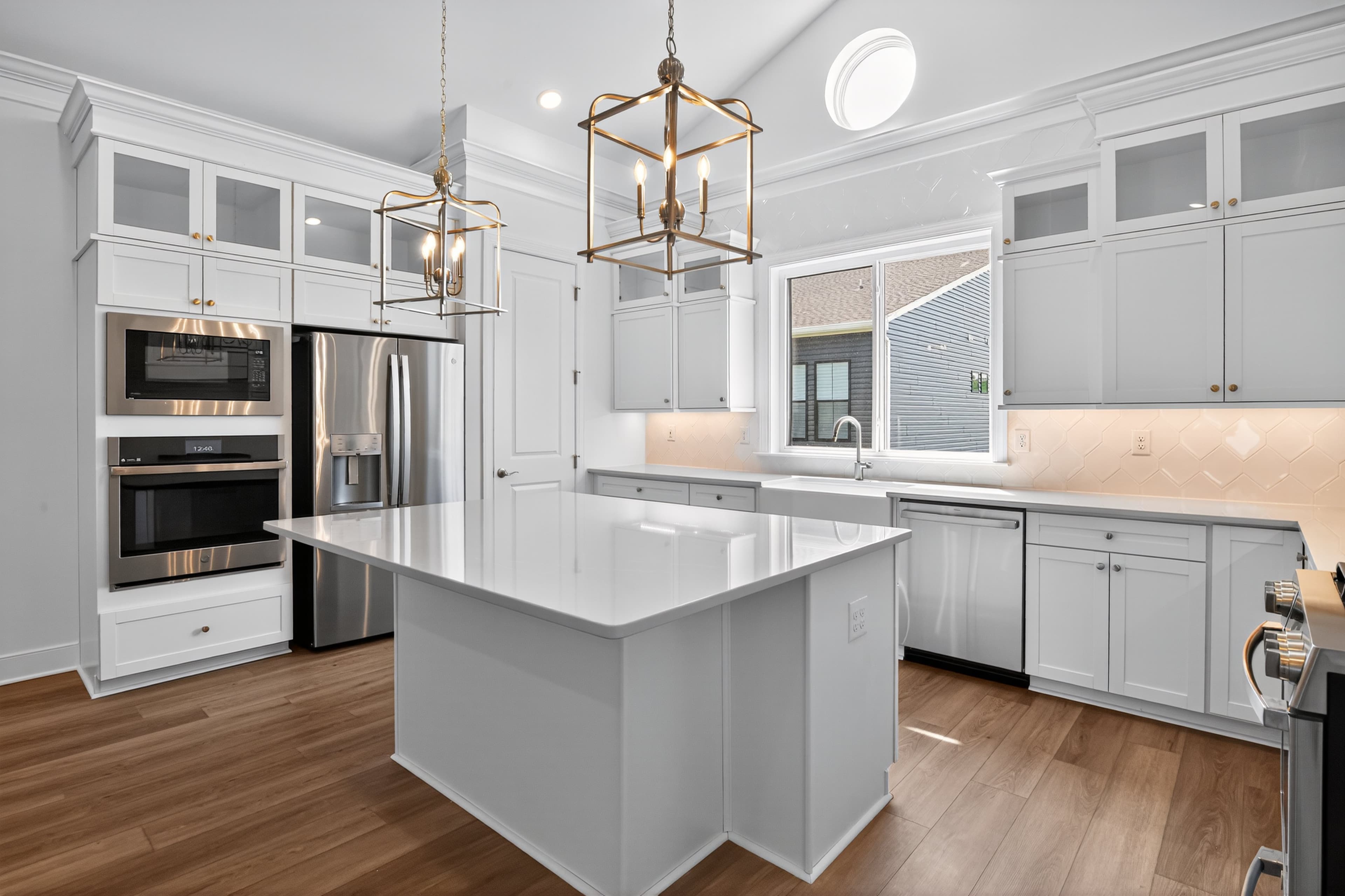 Kithen with upper glass cabinetry and pendant lights