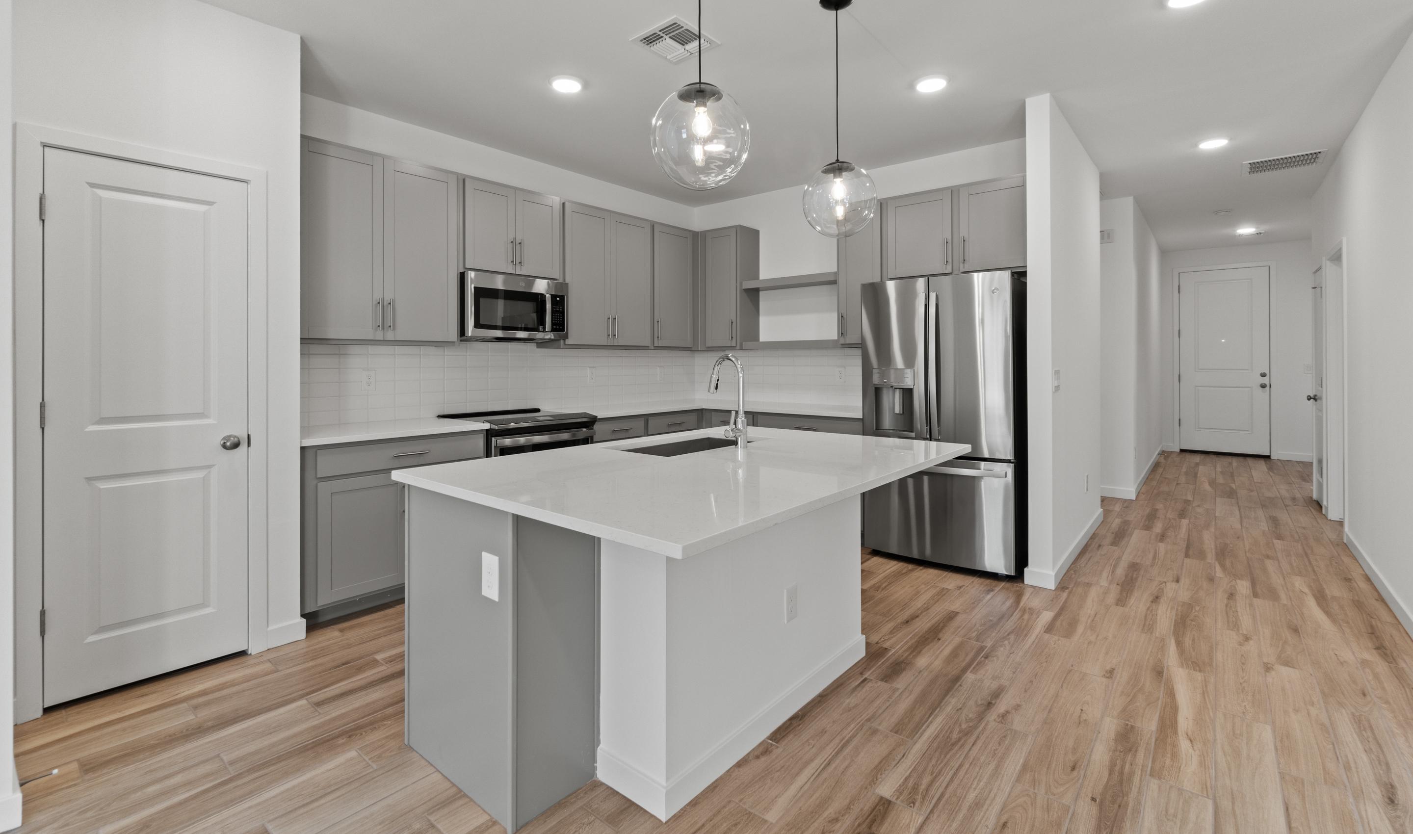 Kitchen with Carrara Miksa quartz island and countertops