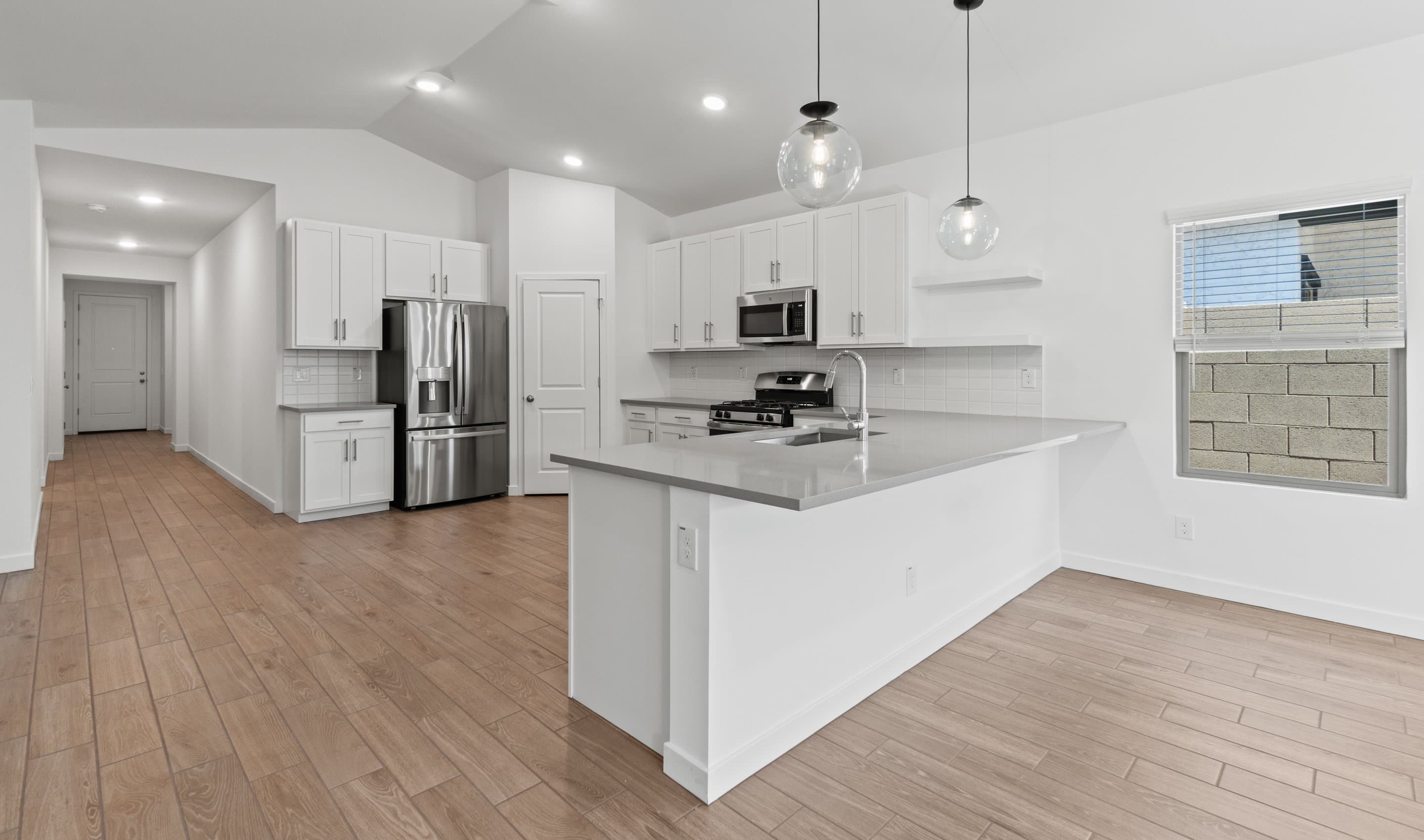 Kitchen with sleek pendant lighting