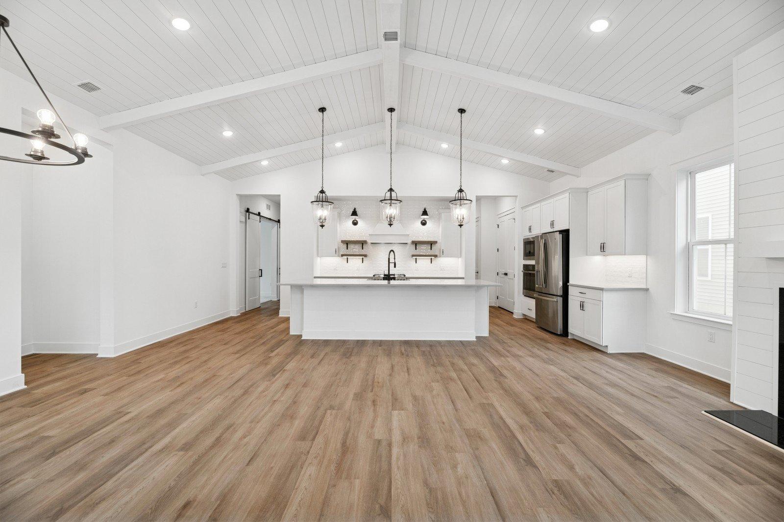 Vaulted ceiling showcases painted beams & shiplap detail