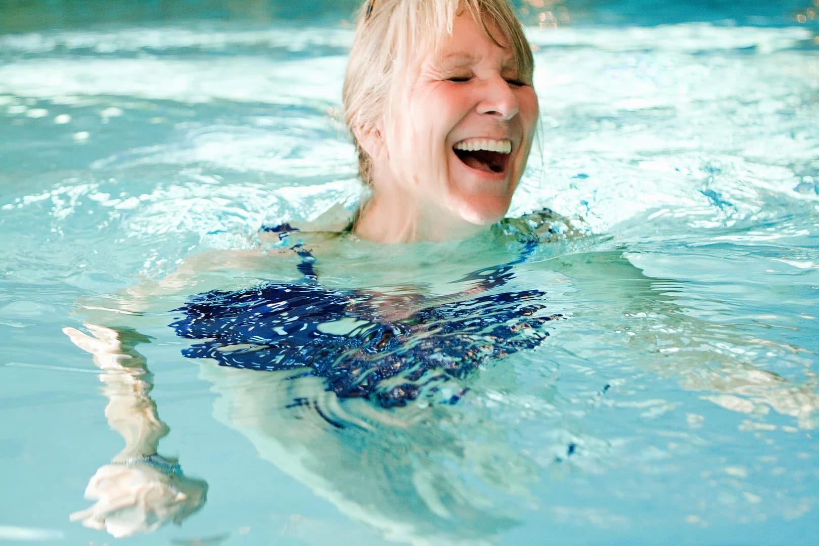Older woman in pool exercising