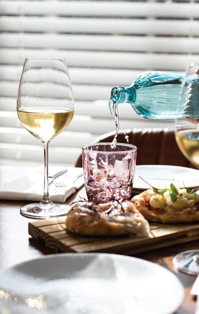 Pouring Water at a Restaurant Table Set for Two