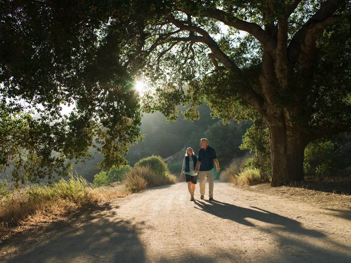 Mature couple waking down dirt road