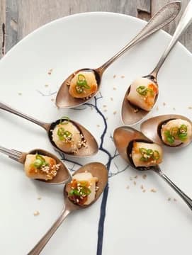 Spoons on a platter with scallop hors d oeuvres