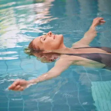 Woman Floating on Her Back in Pool