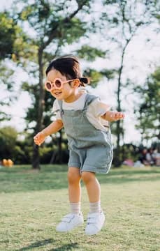 143693 Happy Girl in Flower Sunglasses Jumping in Park USP Crop