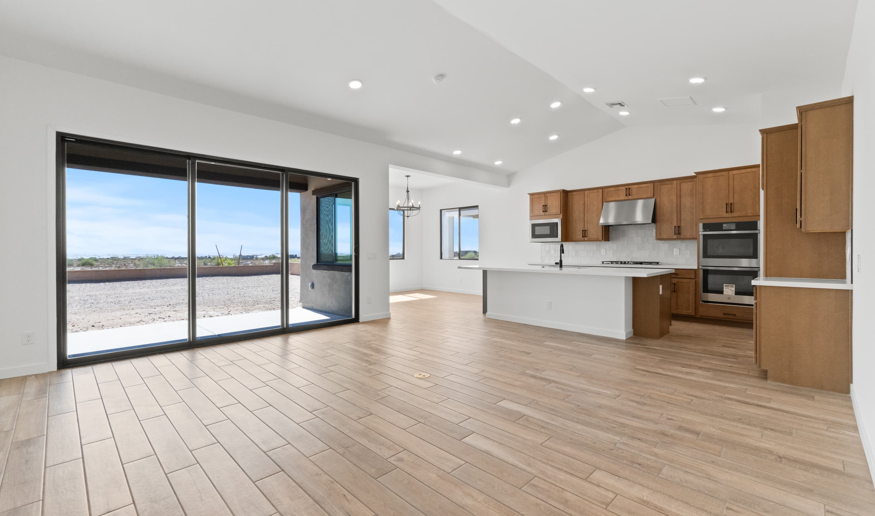 Great room & kitchen united under soaring vaulted ceiling