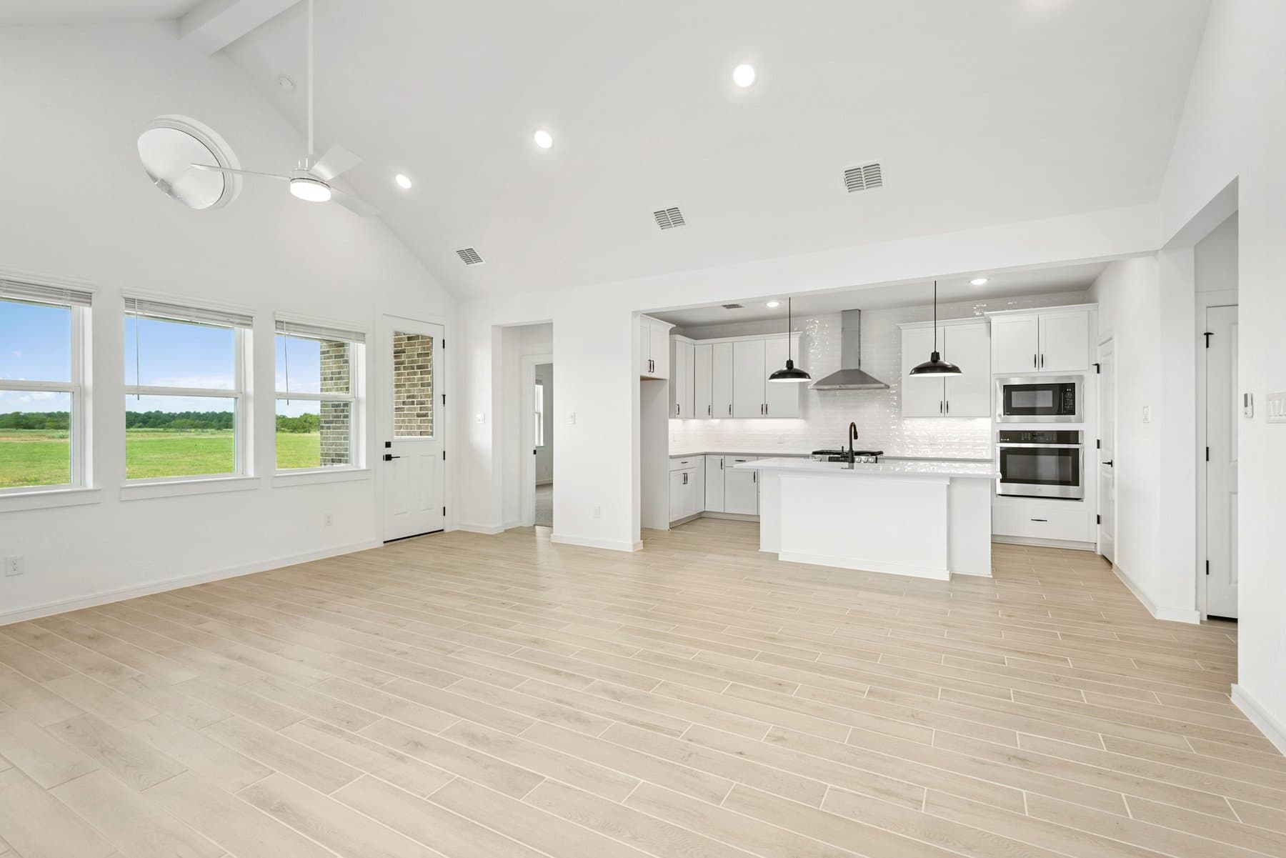 Soaring vaulted ceiling unites main living areas