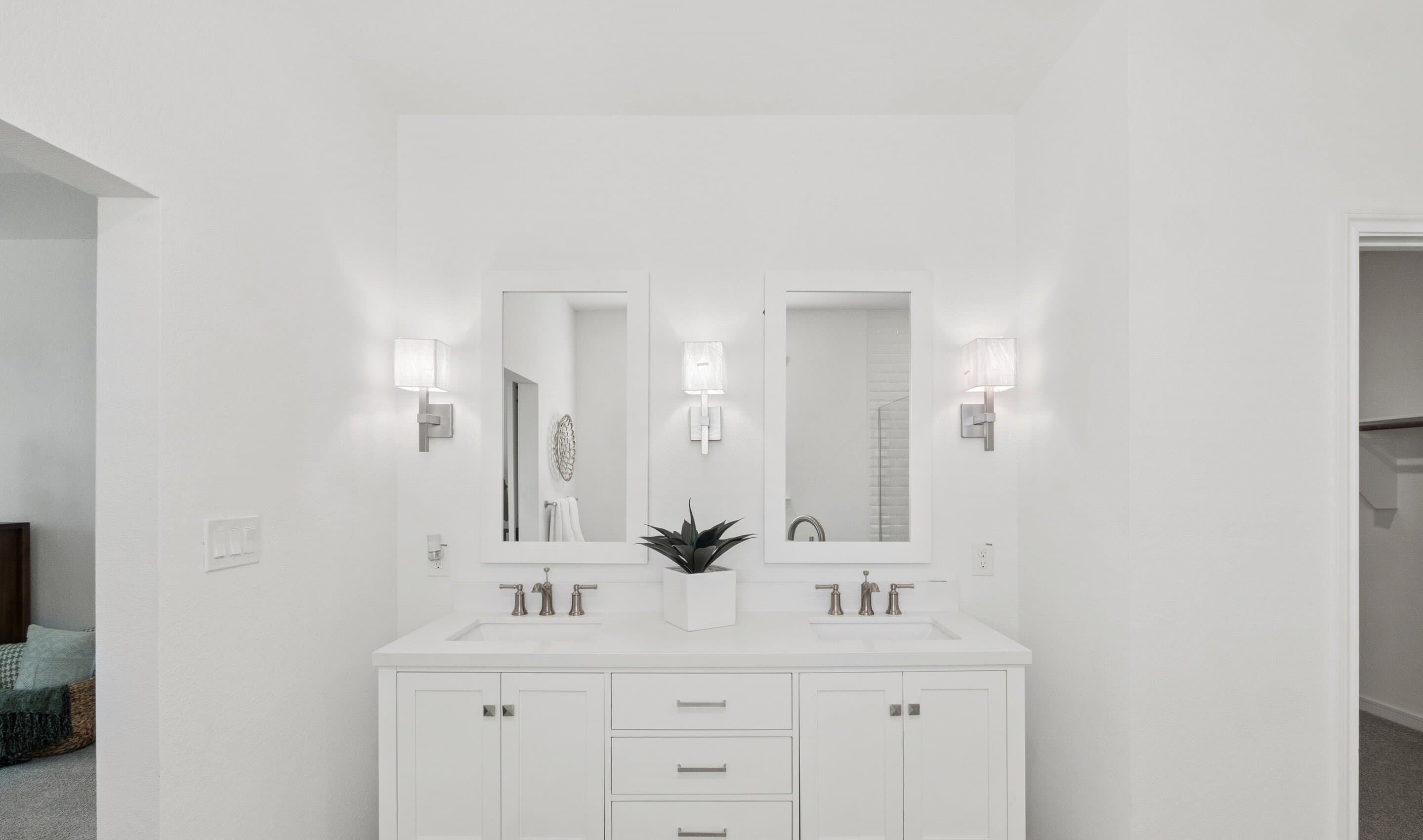 Primary bath features freestanding vanity with dual sinks
