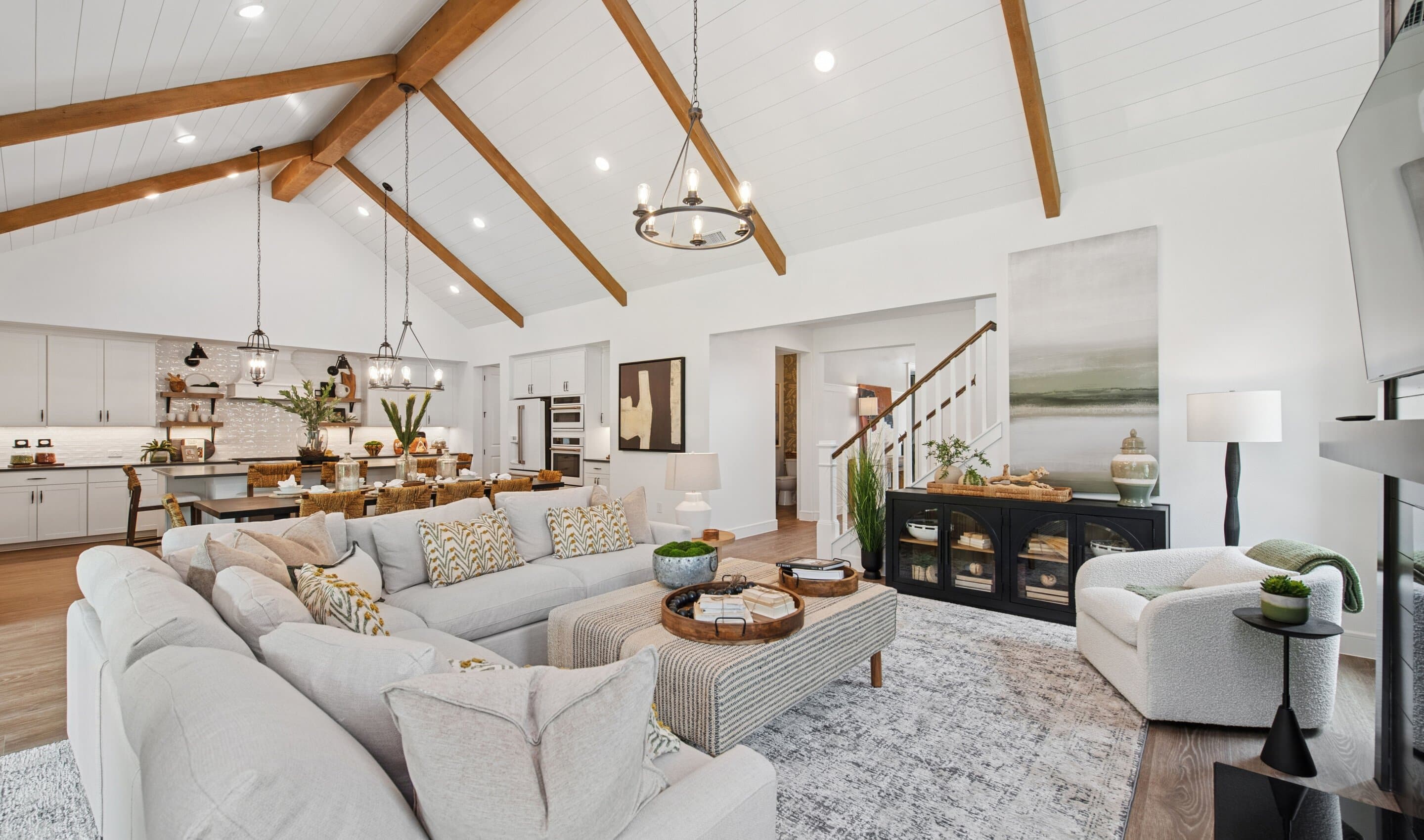 Great room with vaulted ceiling, stained ceiling beams and shiplap