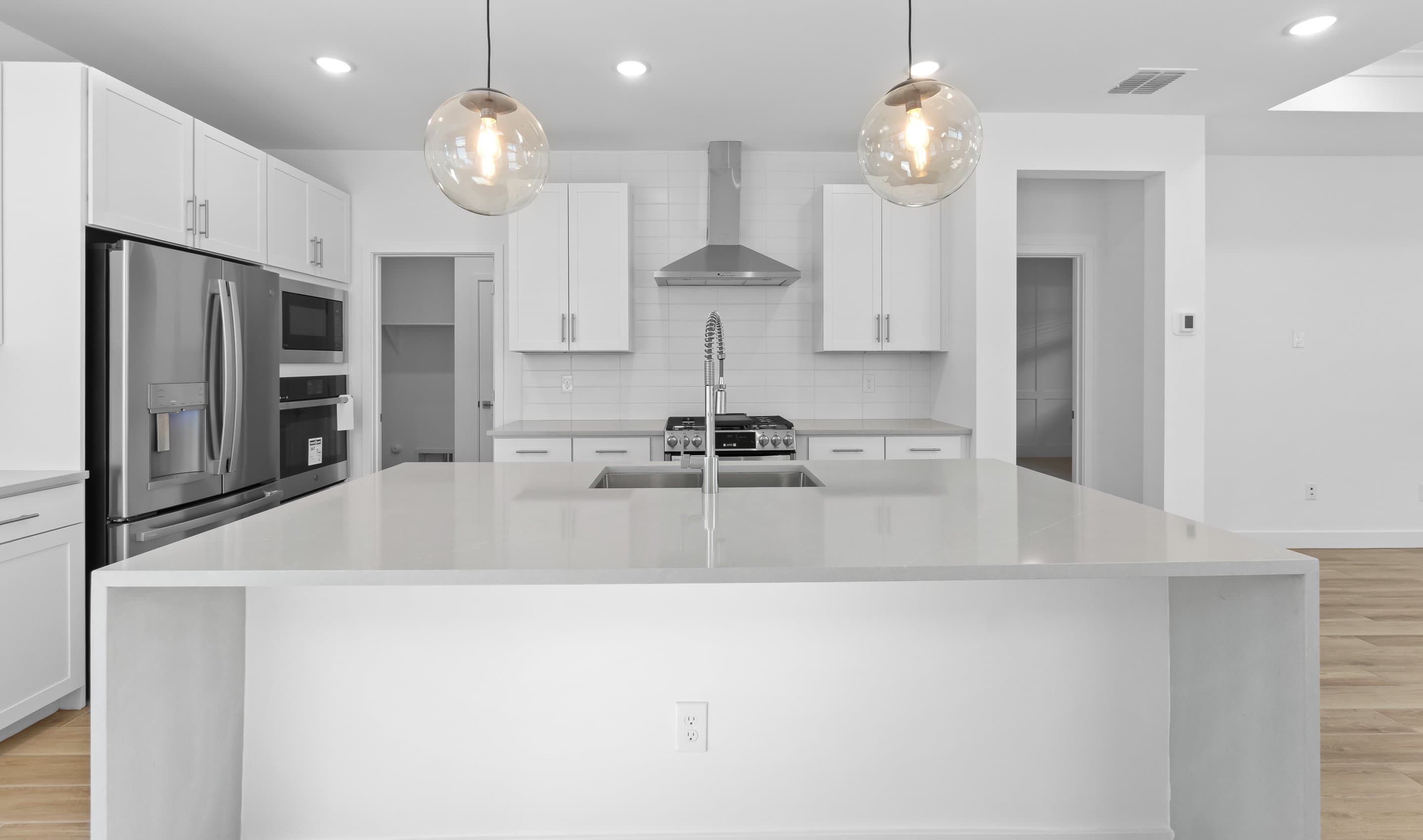 Kitchen with stainless steel vent hood
