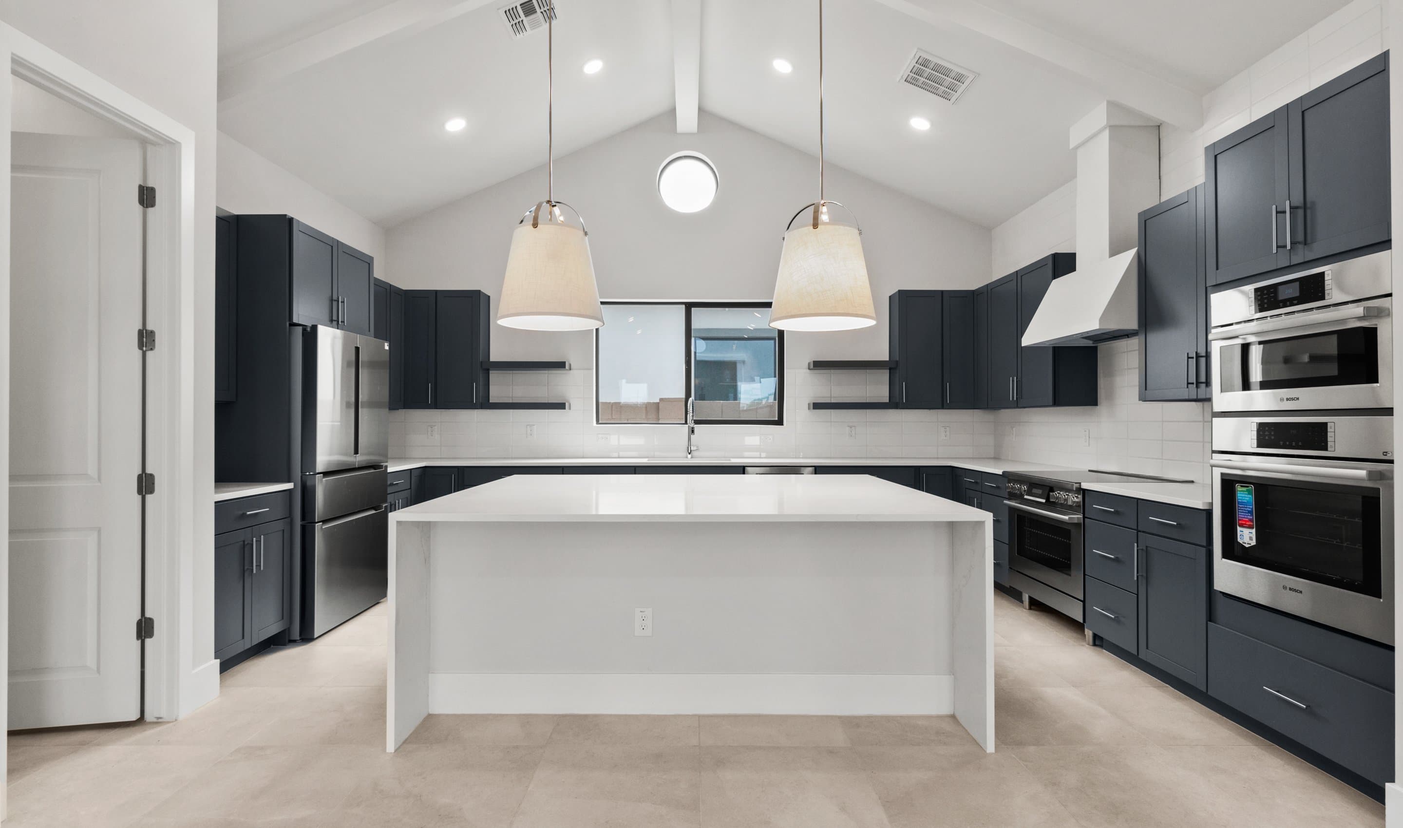 Kitchen with sleek pendant lighting