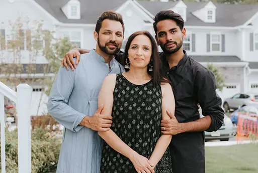 Amit, Amit's mother Anita, and Aditya Shah in front of the Arbors at Monroe townhomes