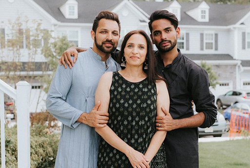 Amit, Amit's mother Anita, and Aditya Shah in front of the Arbors at Monroe townhomes