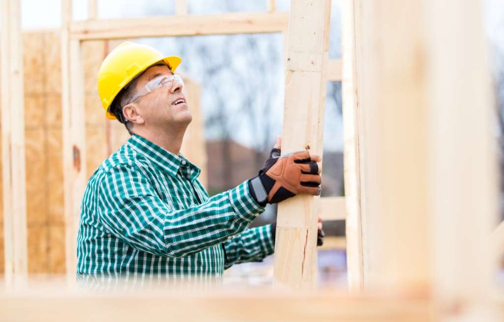 new home construction worker with hard hat building a home